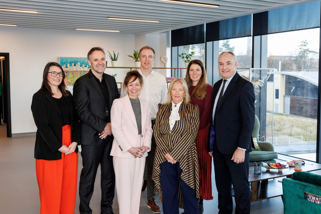 A group of men and women posing for a photo