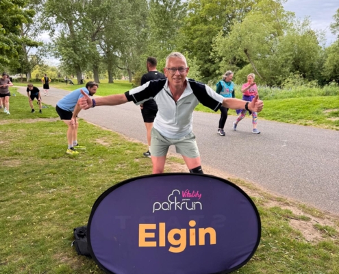 A man in running gear standing in park